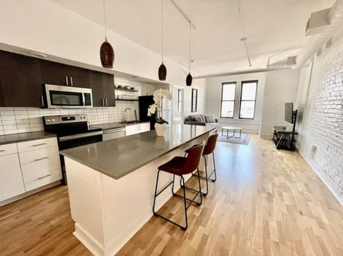 Open floor plan with large eat-in kitchen island and living room space.