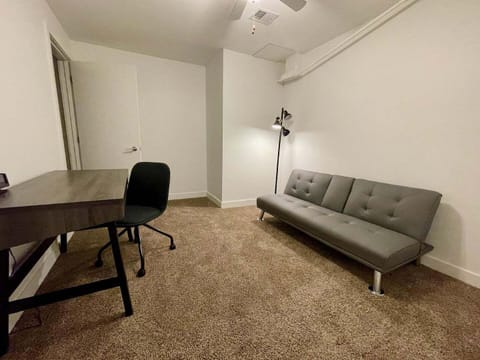 Secondary bedroom with office setup and futon