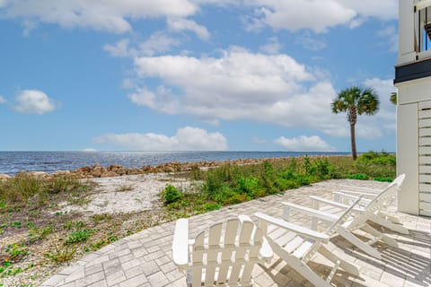 Beach side patio seating steps from the water