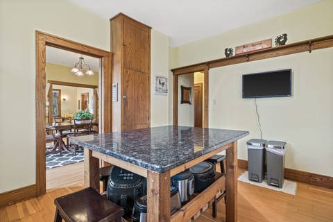 Island in kitchen provides extra seating and room for cooking. 