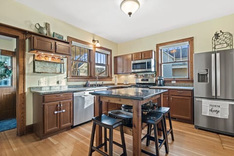 Large kitchen with stainless steel appliances and views to backyard. 