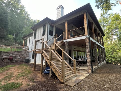 Back side of house with 2 large covered porches overlooking the river