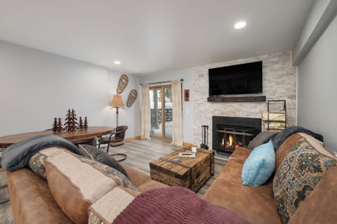 Unwind in your cozy living room where a crackling fireplace creates the perfect ambiance for mountain evenings together.