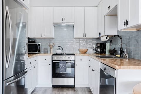 Tiny but mighty kitchen. Full-sized fridge, apartment-sized oven range/stove plus full-sized extra quiet Bosch dishwasher.