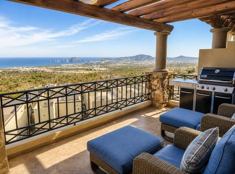 Spacious terrace with cozy seating and a BBQ, ideal for sunset dining.
