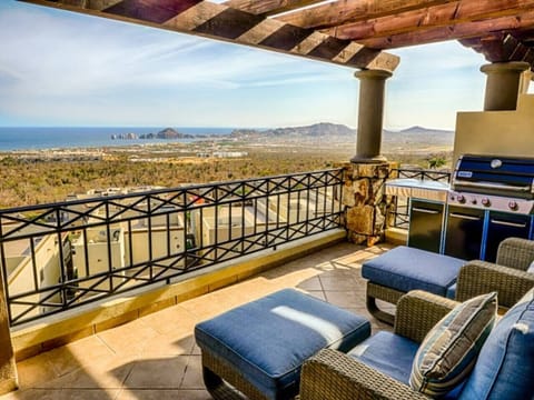 Spacious terrace with cozy seating and a BBQ, ideal for sunset dining.