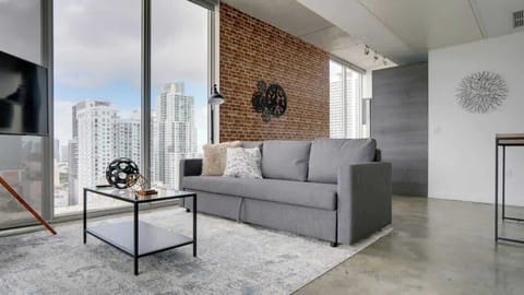 Pristine living room enriched with an abundance of natural light from floor to ceiling window!