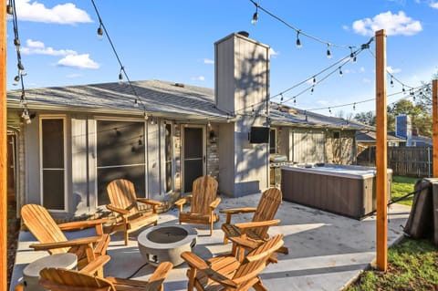 Backyard Patio with Propane Fire Pit Lounge Chairs, Hot Tub, and Grill