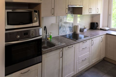 A kitchen featuring modern appliances, including a microwave and an oven.