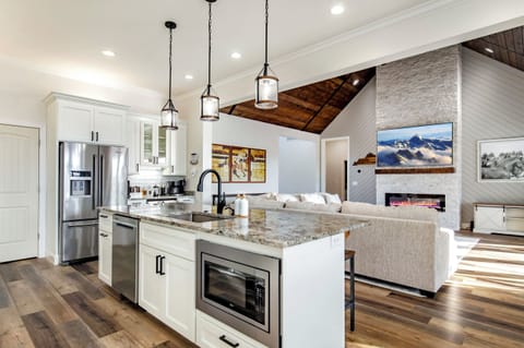 Cook, gather, and unwind in this open kitchen with an 85” TV after a day on the Kentucky Bourbon Trail.
