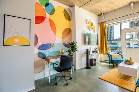 Bright and open living room with vibrant modern decor, featuring a sofa bed for an extra guest or couple