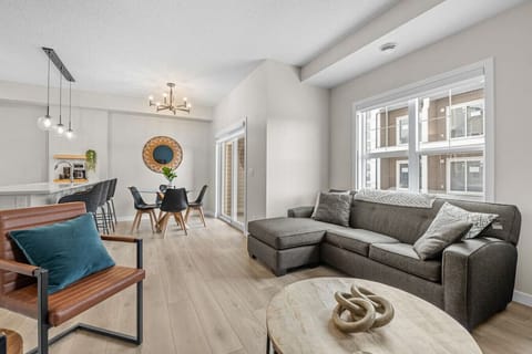 Living room with a Smart TV with cable, cozy seating options and walkout access to the private balcony.