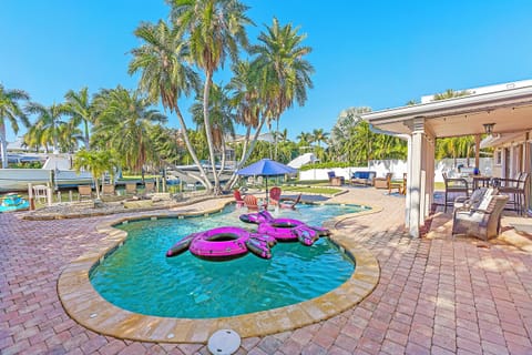 Backyard oasis, heated pool, putting green, pool loungers, and outdoor seating.