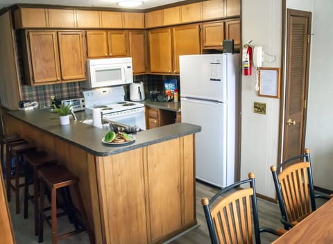 Stocked kitchen with a stove, oven, coffee bar (k-cups and drip machine options), toaster, waffle maker, pots & pans, utensils, plates and glass wear. 