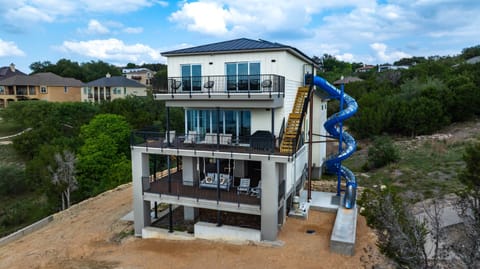 - 4 story slide attached to home adds nonstop fun for your stay - Exciting feature perfect for kids groups and lake travelers - Multiple balconies overlook scenic water views all around