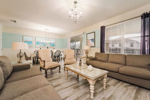 Bright coastal living and dining space with airy natural light, stylish seating, and an open layout perfect for gathering.