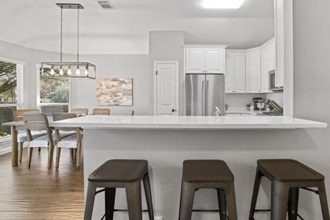 Keep everyone together—open kitchen and dining with bar seating make this cozy Cedar Park home perfect for families and work trips.