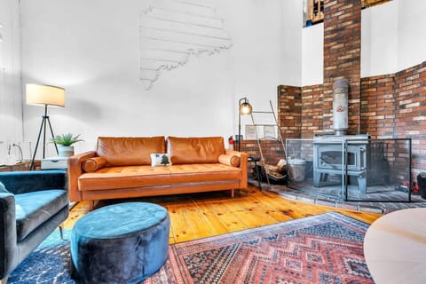 Get cozy on our comfortable leather couch and embrace the warmth of the inviting fireplace. Relax, unwind, and make lasting memories in this perfect retreat for ultimate comfort!