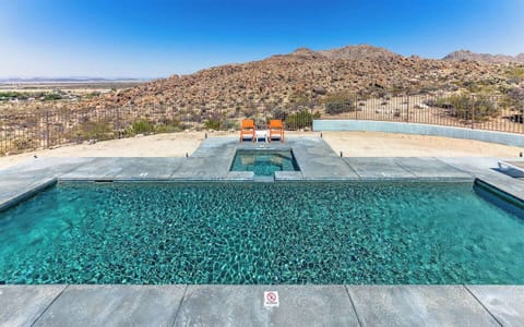 Private heated pool at Casa Altura Joshua Tree vacation rental with panoramic desert and mountain views.