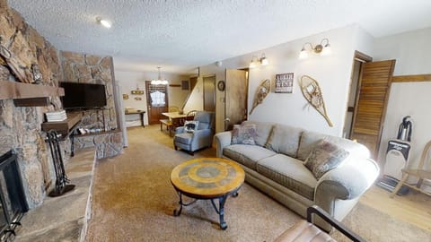 Relax by your own stone fireplace, surrounded by rustic charm and cozy seating, with everything you need for a perfect mountain getaway.