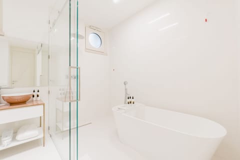 One Bedroom Suite | Bathroom | Rainfall showerhead, hair dryer, bathrobes, slippers