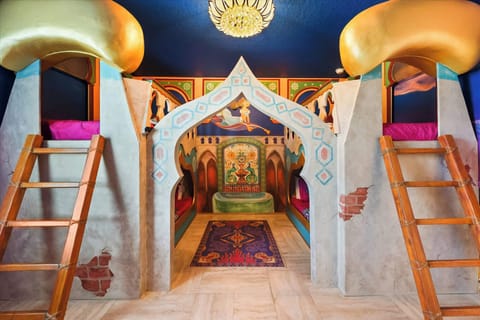 Experience a magical adventure in this enchanting themed room with cozy bunk beds and vibrant decor, perfect for family fun.
