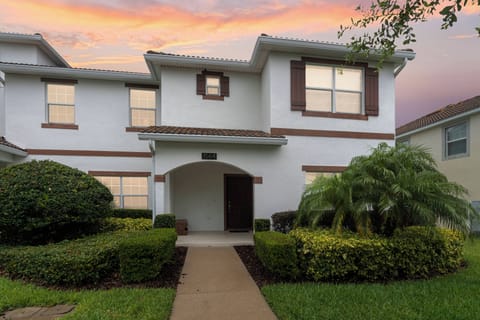 Welcome to this charming home, where lush greenery greets you at the entrance. The warm facade and inviting archway lead to bright interiors, while the vibrant sunset backdrop adds to the overall allure of your stay.