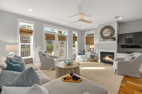 Bright living room with a fireplace, comfortable seating, and coastal decor.
