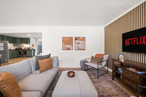 The living room blends modern style with comfort, complete with Netflix and board games for laid-back nights in.