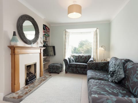 Comfortable living room with feature fireplace | End House, Salcombe