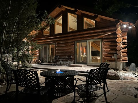Backyard flagstone patio with firepit.  Cushions provided for chairs and chaise.