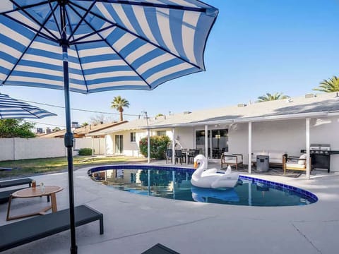 Spacious Entertainers Backyard featuring a Sparkling Blue Pool, Outdoor Furnishings, Fire Pit, and Yard Games