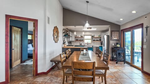 Spacious dining table with kitchen access, perfect for large meals.