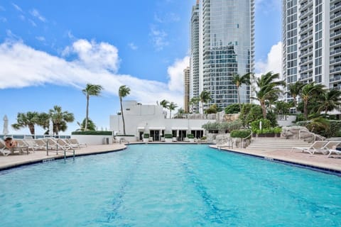 Dive into refreshing waters! Sunshine and relaxation by the pool.