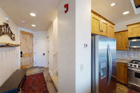 This thoughtfully designed entry maximizes space and accessibility. It leads directly into a modern, airy kitchen, providing an inviting and organized hub for your next adventure.