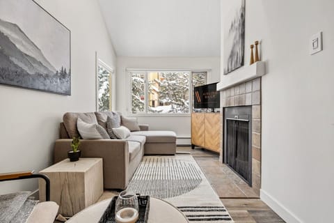 Living room with cozy seating options, a Smart TV and a decorative fireplace (glow logs only please!)