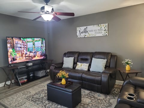 Comfortable leather sofas with 75 inches TV, plus XUMO 4K UHD streaming device.
