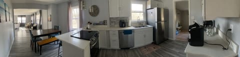 Panoramic view from the back of the kitchen, dining area to the Great room
