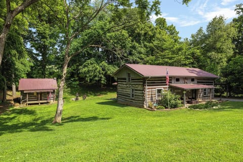 Charming log cabin retreat with spacious lawn, porch, and wooded privacy