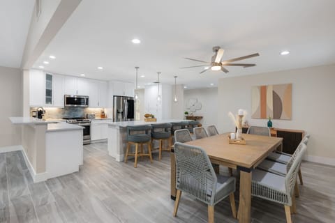 Large dinning room with seating for 8 and additional 4 barstools at island