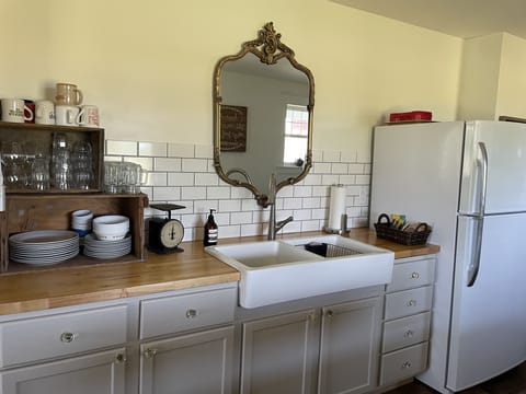 Kitchen with all the basic kitchen supplies as well as oil and spices