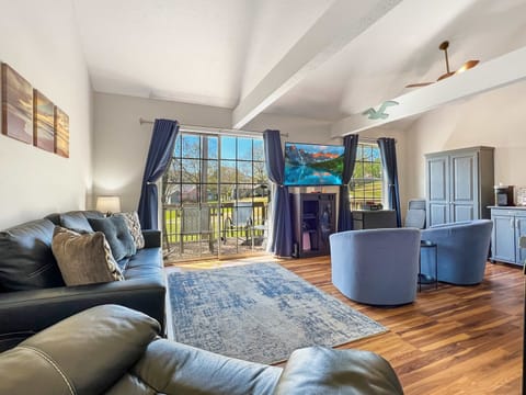 Beautiful living area with recliner, queen sofa bed, streaming tv and access to the stunning deck overlooking pointe royale golf course. 