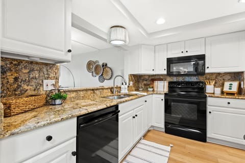 Bright, fully-equipped kitchen w/ granite countertops & plenty of storage