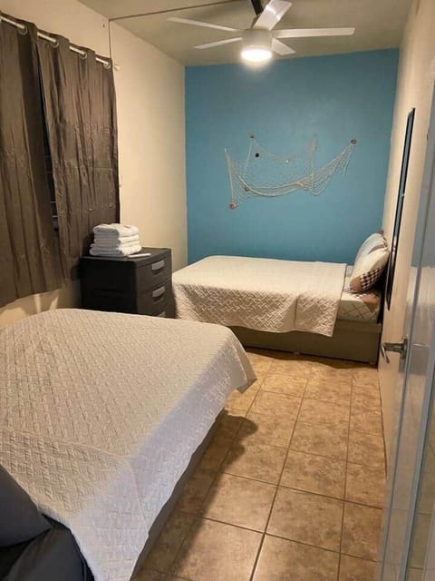 A bedroom with 2 confortable full beds to accommodate up to 4 people. An inverter air conditioned, ceiling fan and a drawer. 