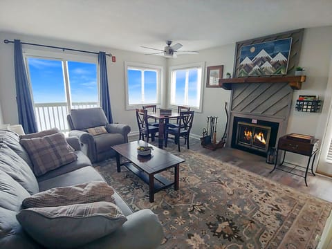 Great living room with 2 decks, fireplace, sleeper sofa, kitchen. 