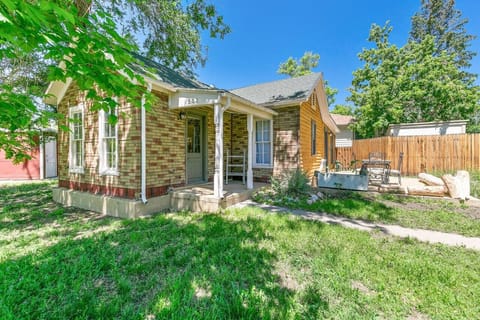 Quaint brick house, nestled amidst the vibrant green fields.