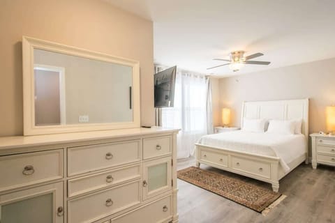 Cozy and clean white Queen sized bed to sleep and relax; and drawers to organize your things.
