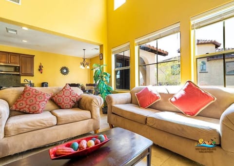 Large windows in the living room bring in natural light and offer golf course views — creating a bright, open space .