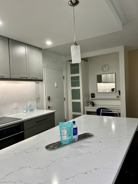 Kitchen view towards foyer/entryway and desk area.