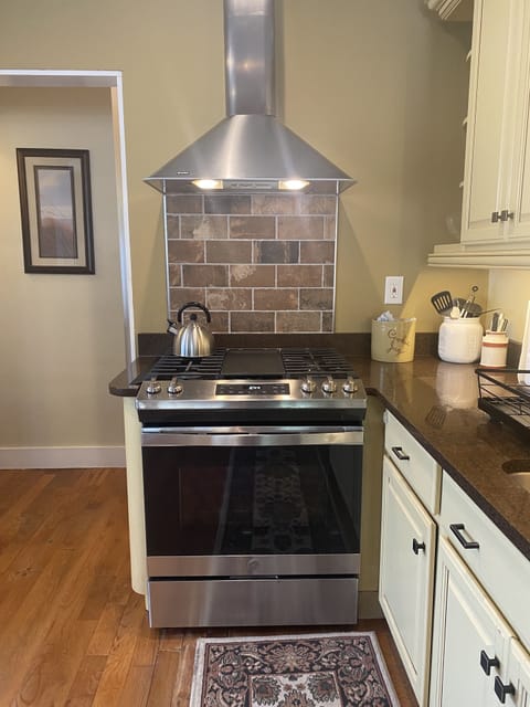 Large gas stove with heat/light vent. 